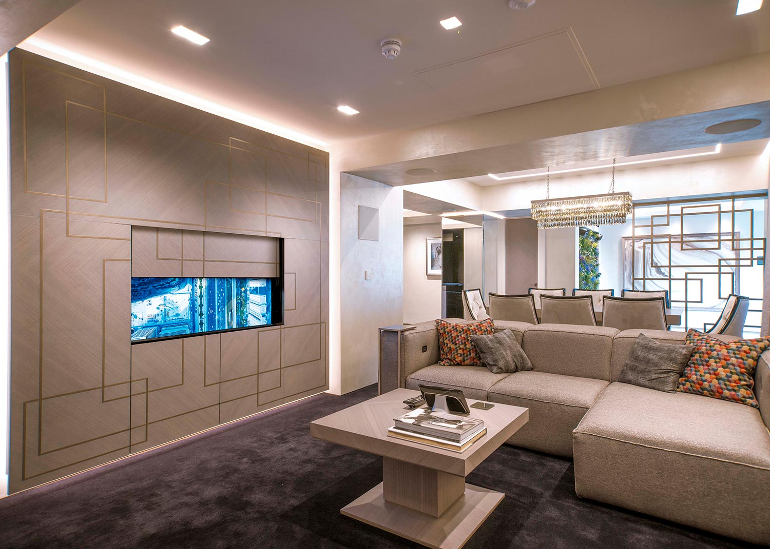 Modern living room with built in TV wall and neutral furniture