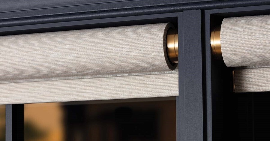 A close-up of Lutron Palladiom shades fully rolled up.