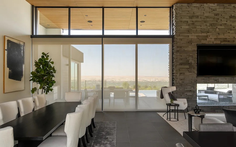 Modern Bountiful living area with motorized shades lowered, filtering the sun from the patio.