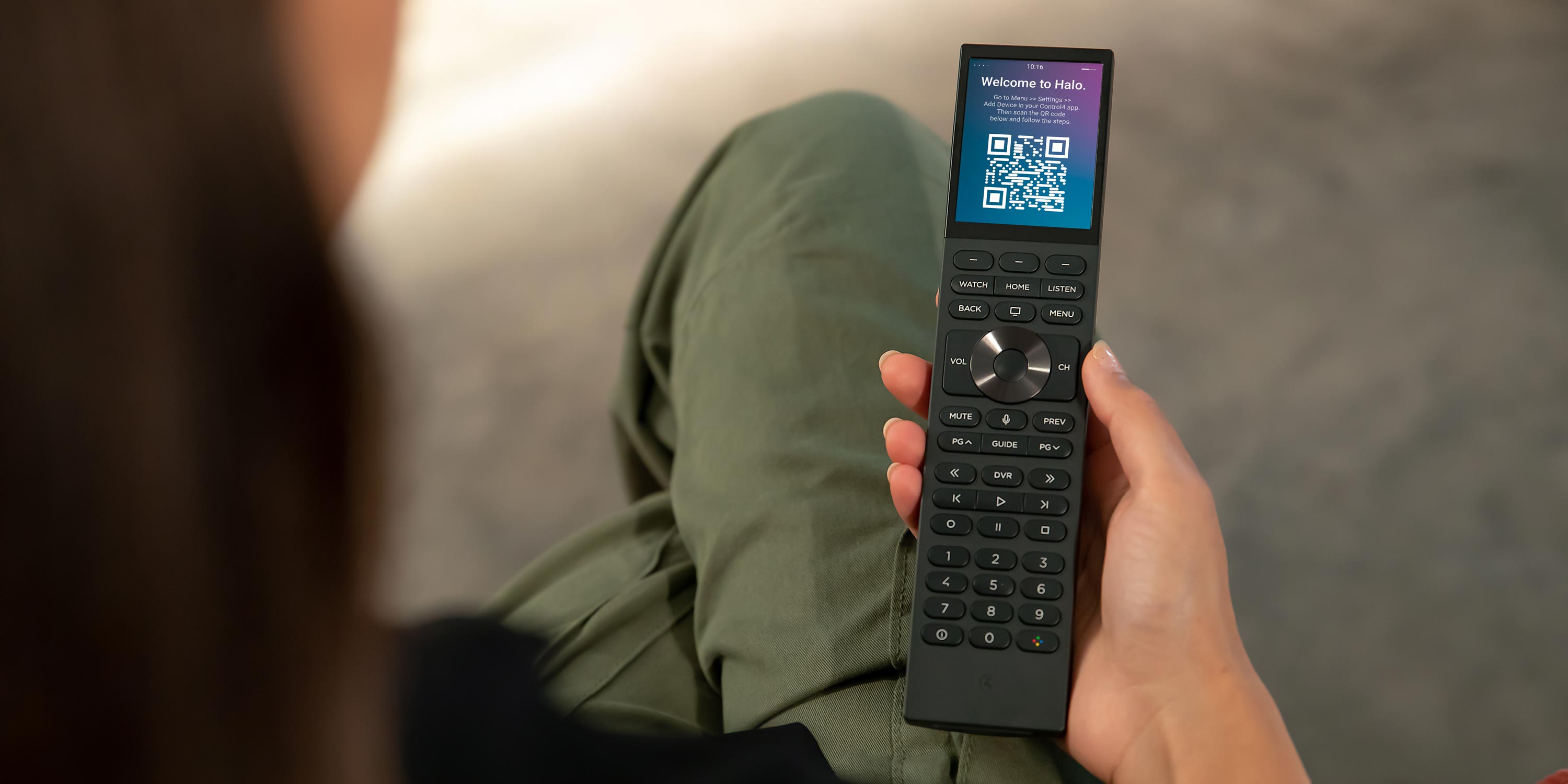 Red control4 neeo remote on black couch