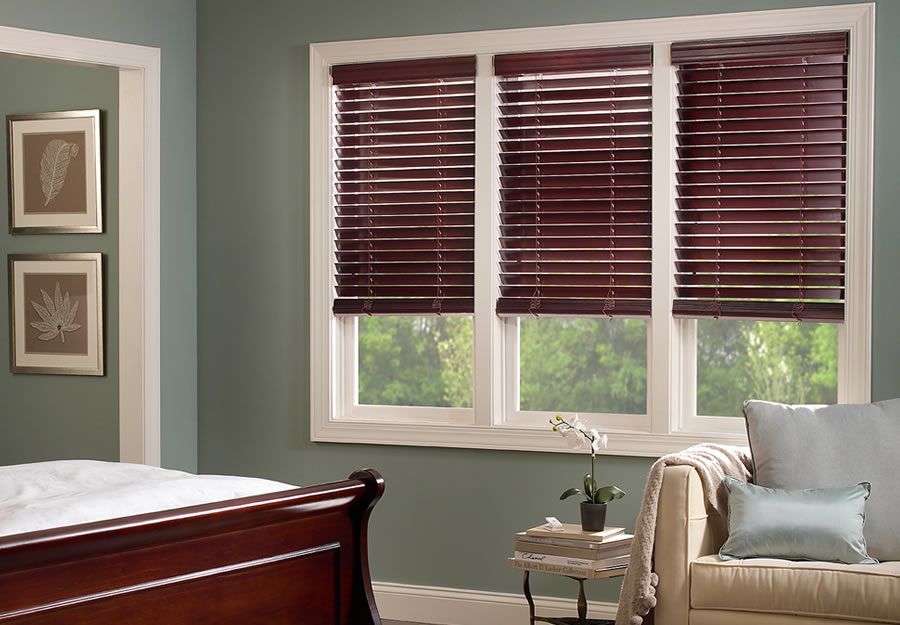 burgundy wooden blinds in a green room lutron